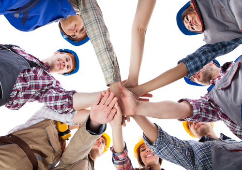 Large,Group,Of,Construction,Worker,Stacking,Hands.,Isolated,On,White